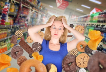 Diet Woman At Grocery Store With Junk Food