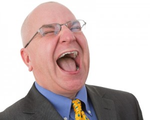 Middle-aged Bald Businessman Laughing Out Loud